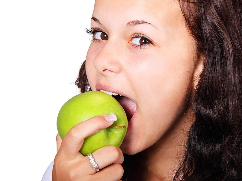 A Lady eating apple