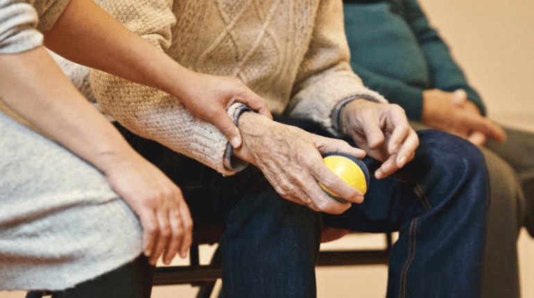 A old man holding a stress ball