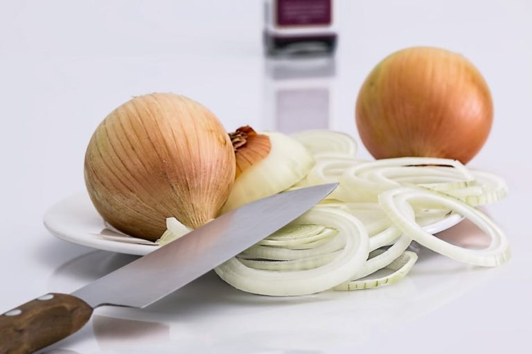 onions and knife on a table