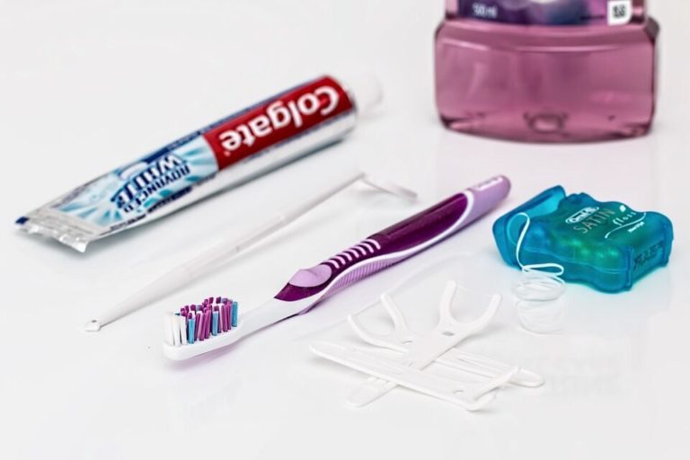 A toothbrush and toothpaste alongside various dental care items