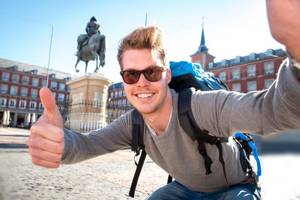 A tourist posing in front of camera